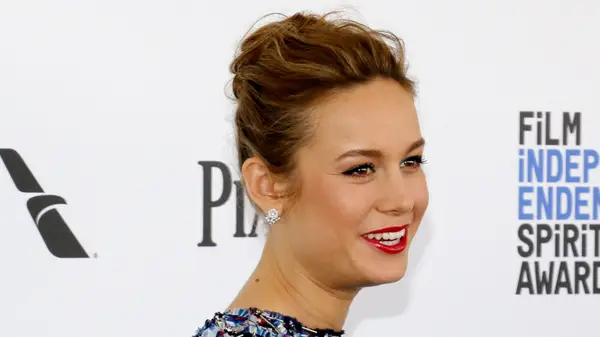 Brie Larson on the red carpet with her hair up in a messy bun