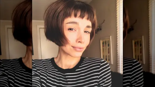 Woman with a short bob and bangs