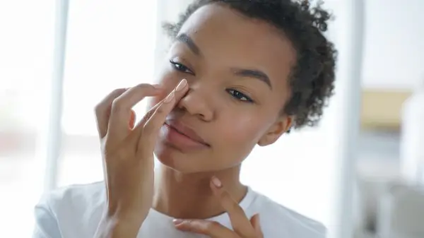 Woman putting on eye cream