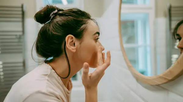 Woman looking in a mirror