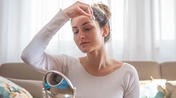 Woman applying serum