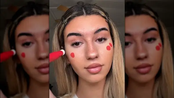 Woman applying red blush