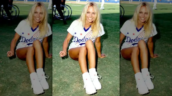 Pamela Anderson posing at a charity baseball game in 1992