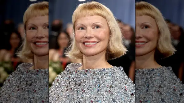 Pamela Anderson smiling at the 2025 Met Gala with a chin-length cut and baby bangs