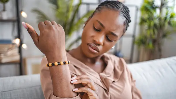 Woman scratching arm