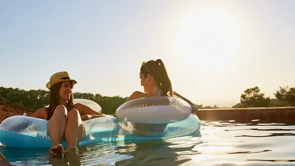 friends lounging in water