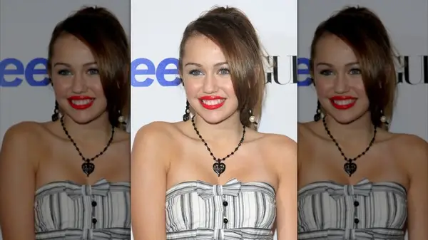 Miley Cyrus on the red carpet wearing red lipstick