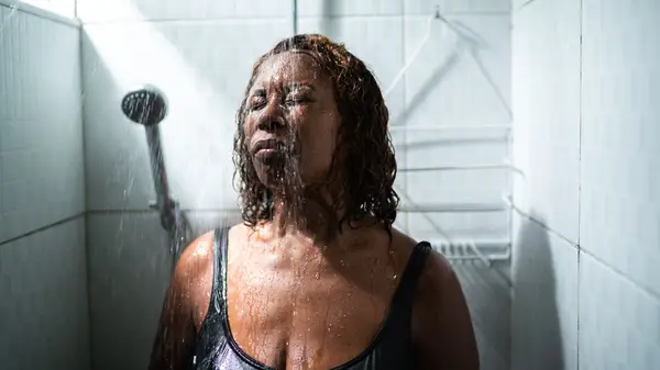 A woman rinsing her hair