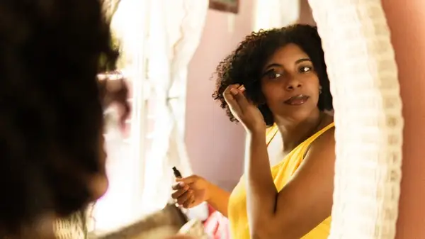 A woman applying mascara