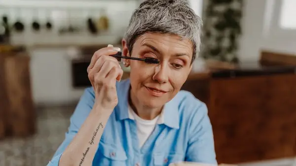 Woman applying mascara