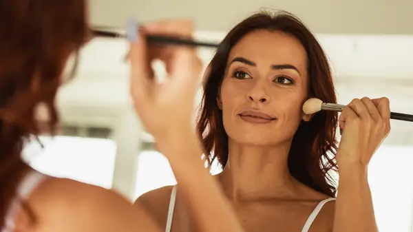 Woman applying blush