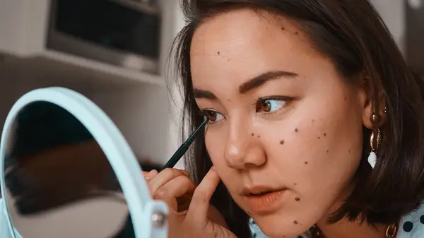 Woman applying eyeliner