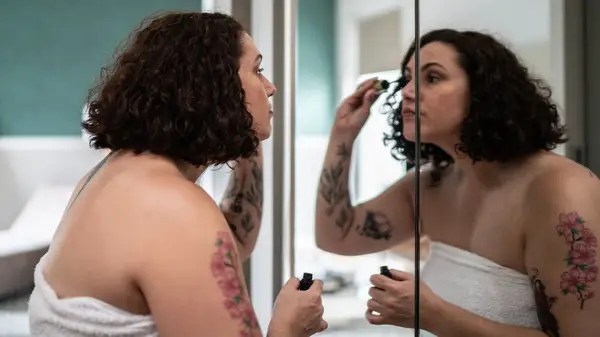 Woman applying mascara