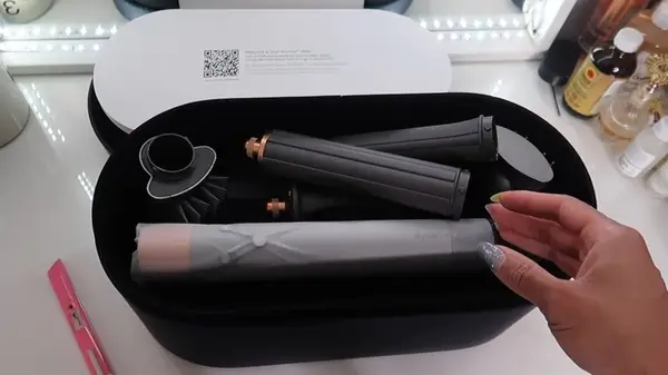 Woman holding Airwrap and a FlexStyle