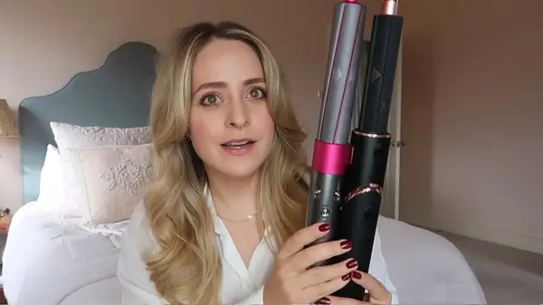 Woman holding an Airwrap and a FlexStyle