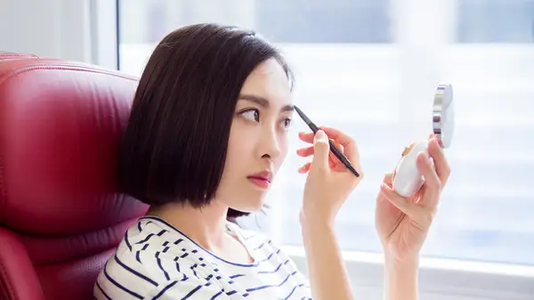 Woman doing eyebrows