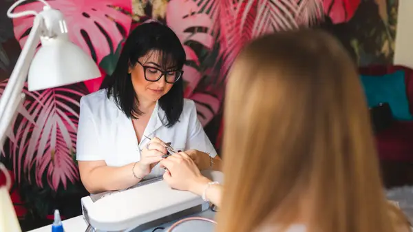 A nail tech with bright background 