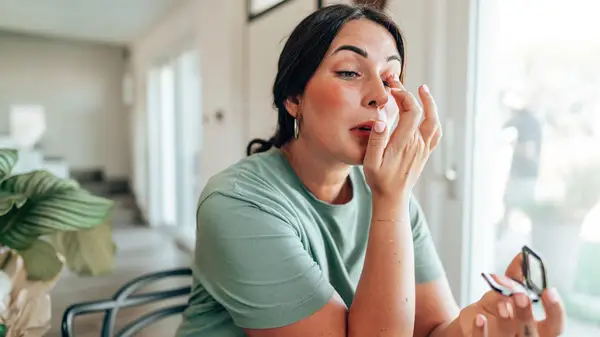 Woman applying makeup