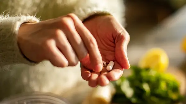 Person holding supplements