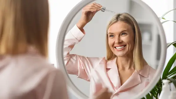 Woman applying hair oil