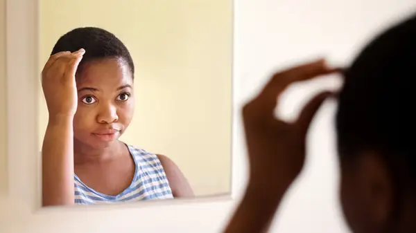 Woman touching her head
