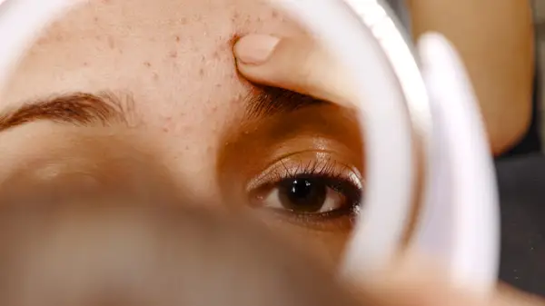 Woman examining reflection