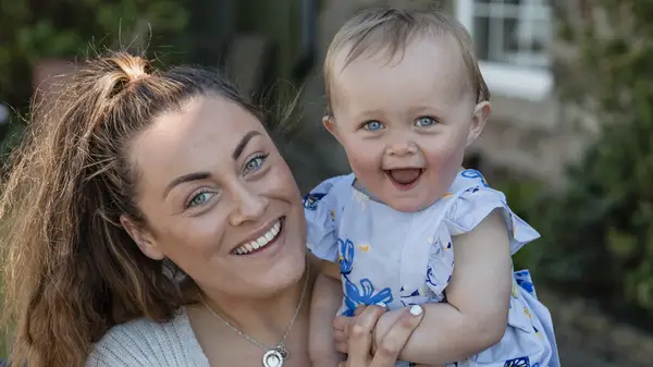 A woman and baby with blue eyes