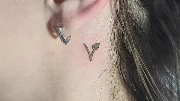 Vegan behind the ear tattoo