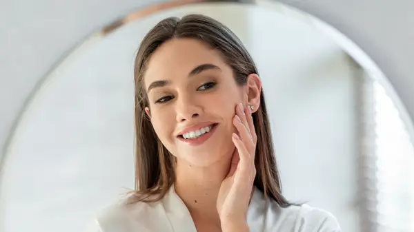 woman looking at skin 