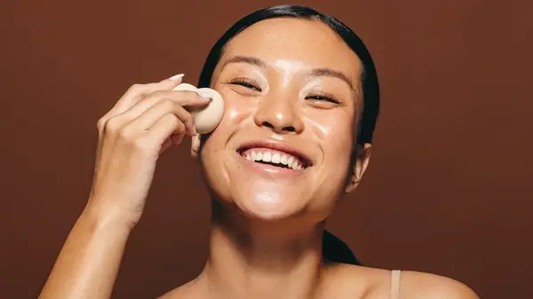 Woman using beauty blender sponge