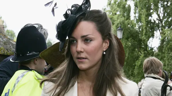 Kate Middleton in a beige blazer and black fascinator in 2005
