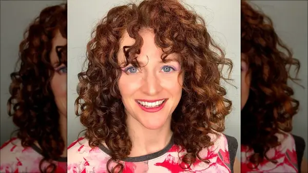 Woman with curls and bangs