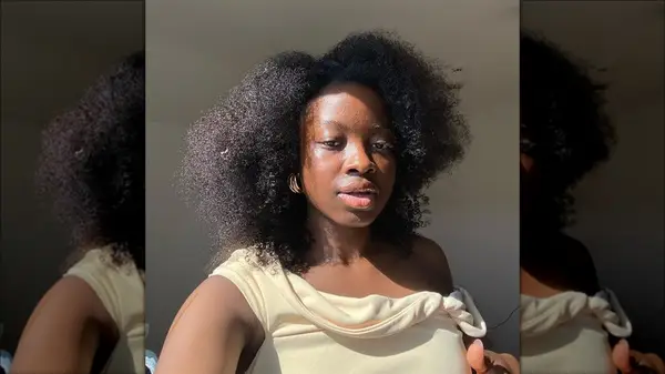 Woman with a side-part afro