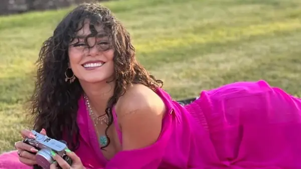 Vanessa Hudgens smiling and showing her naturally curly hair