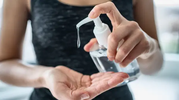 Person pumping hand sanitizer