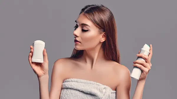 woman using antiperspirant