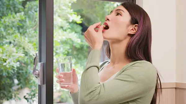 woman taking natural supplements 