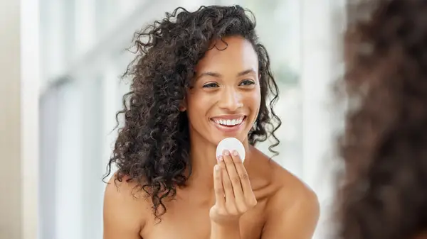 woman applying toner with pad
