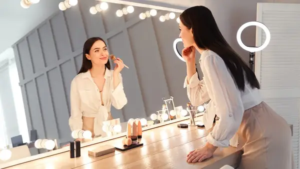 woman applying makeup
