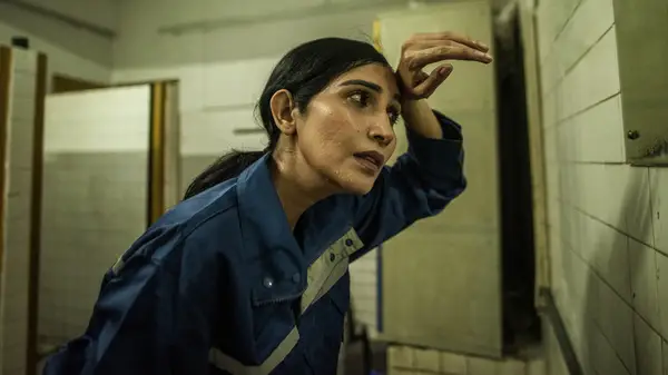 woman wiping off face sweat