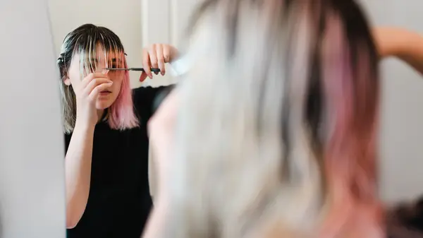 woman cutting her own hair