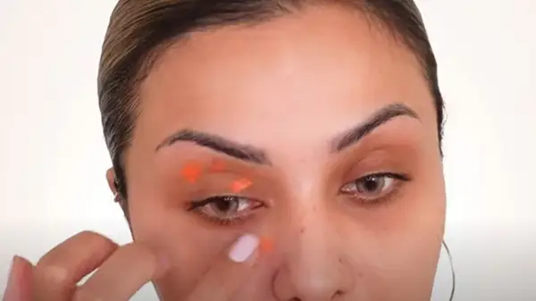Woman wearing orange color corrector