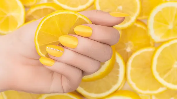 lemon yellow nails on lemon background