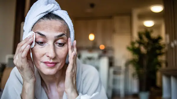 A woman doing her skin care routine