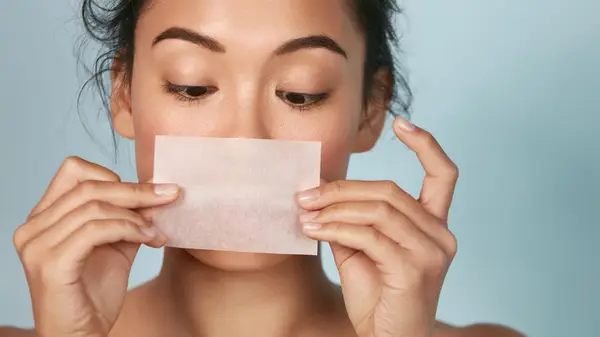 woman with blotting sheet 