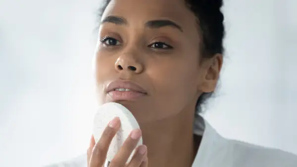 Woman applying skincare
