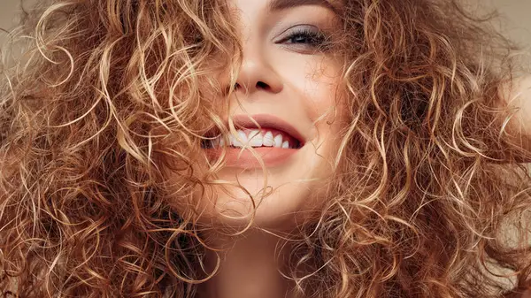 Woman with curly highlighted hair