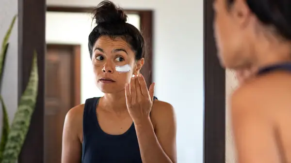 Woman applying sunblock