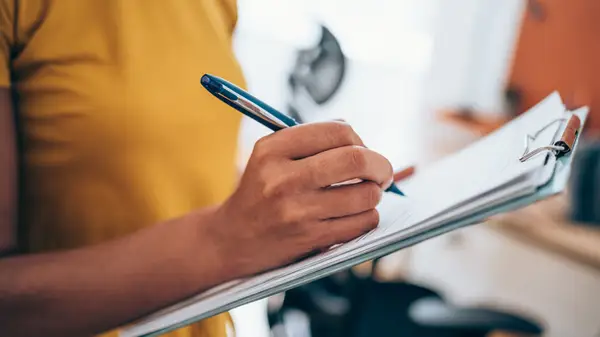Woman writing with pen