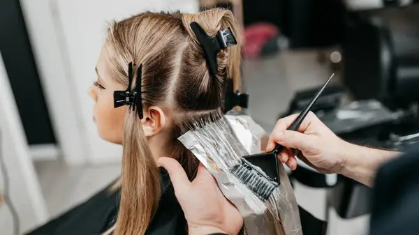 Woman having hair dyed